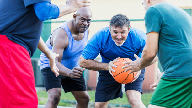 istock Mature men having fun playing basketball 1169240437