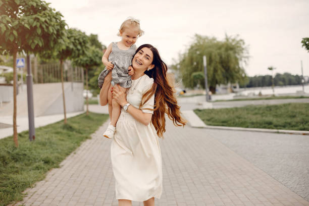 istock Mother with daughter playing in a summer park 1169240440