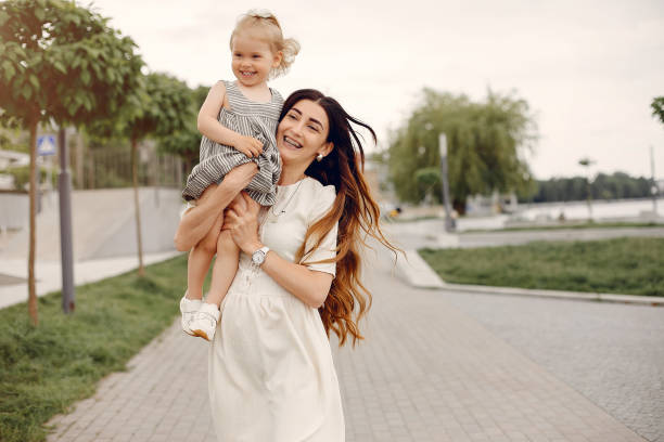 istock Mother with daughter playing in a summer park 1169240445