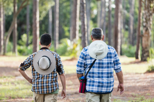 istock Hispanic boy and father hiking in woods 1169242109