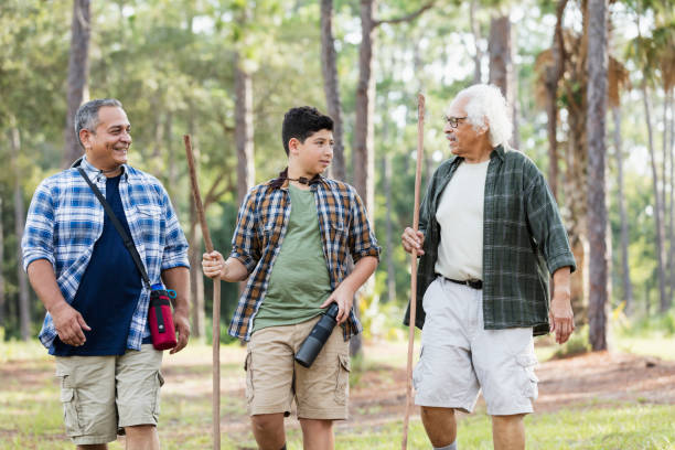 istock Multi-generation Hispanic family hiking in woods 1169242227