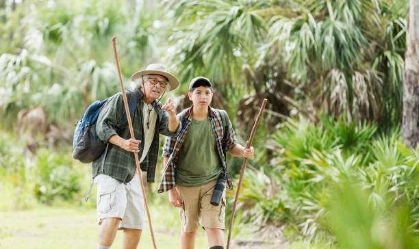 istock Hispanic boy hiking with grandfather 1169242906