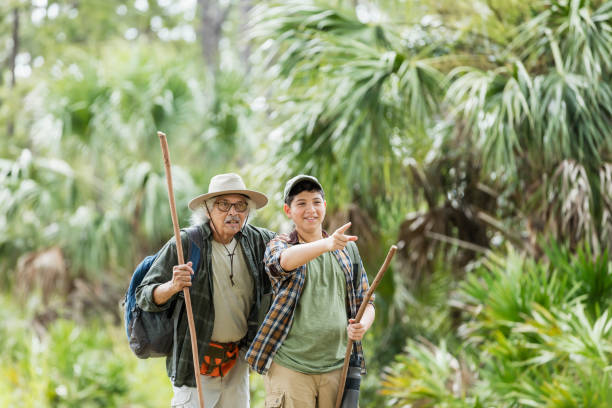 Hispanic boy hiking with grandfather