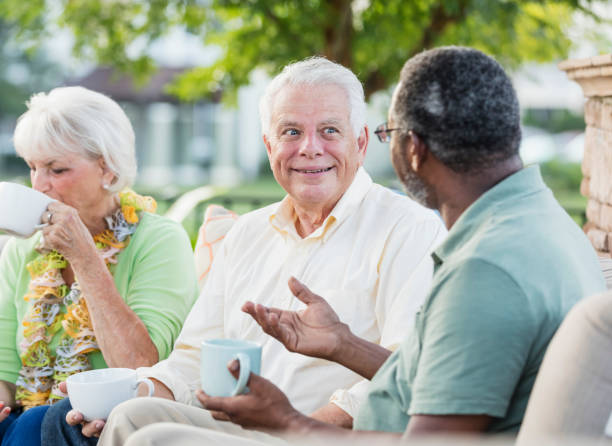 istock Senior man conversing with friend over coffee 1169243136