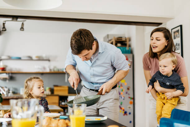 istock Young father serving breakfast to his family 1169246425