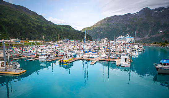 This image is a top down (birds eye view) of the boat dock located at Whittier, Alaska. The image was taken using a DJI Mavic Air and was taken at an altitude of 300 feet. The image shows all of the fishing and leisure boats parked in the harbor. During the winter in Whittier, the average temperature drops to below freezing, making this boat dock covered in ice and snow.