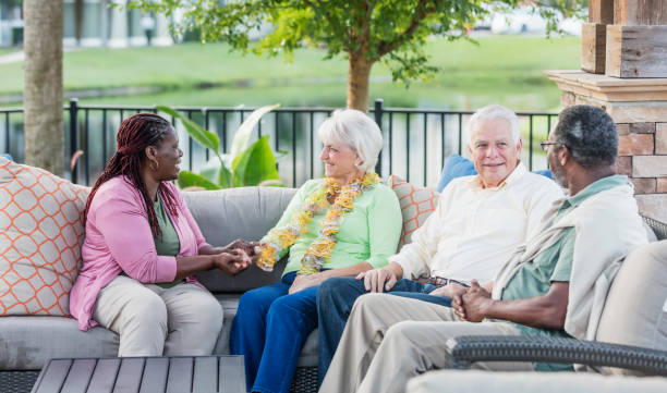 istock Two older couples hanging out on patio, conversing 1169248757