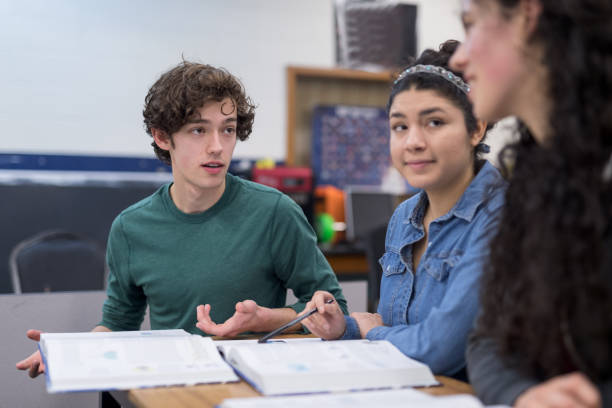 istock High school students work on an assignment together at their desks 1169248835