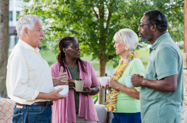 istock Two older couples hanging out on patio, drinking coffee 1169248956