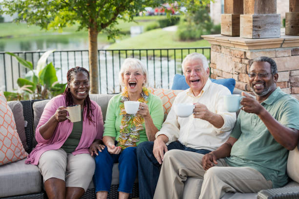 istock Two older couples hanging out on patio, drinking coffee 1169248958