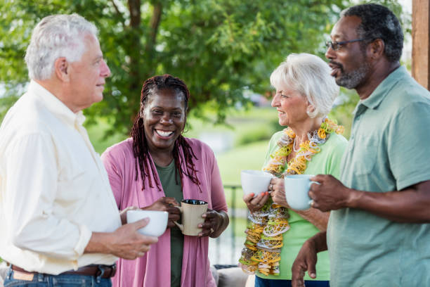 istock Two older couples hanging out on patio, drinking coffee 1169249056