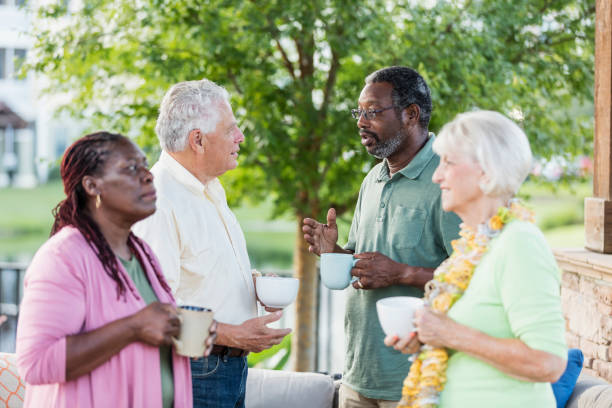istock Two older couples hanging out on patio, drinking coffee 1169249198
