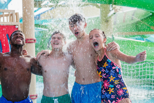 istock Multi-ethnic teenagers at water park getting drenched 1169252261