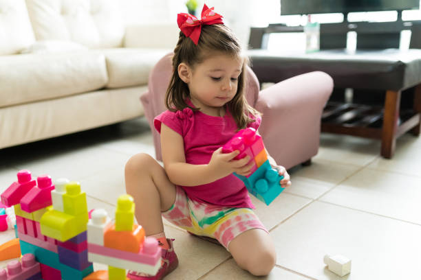 istock Little Kid Playing With Blocks At Home 1169252293