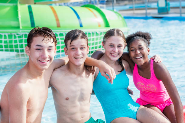 istock Multi-ethnic teenagers having fun at water park 1169252374