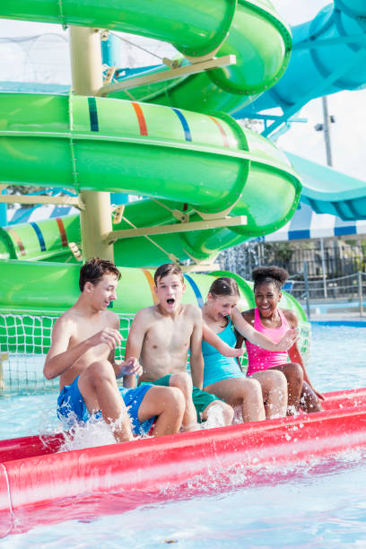 istock Multi-ethnic teenagers having fun at water park 1169252412