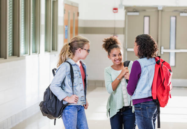 istock Three multi-ethnic girls in elementary school hallway 1169255693