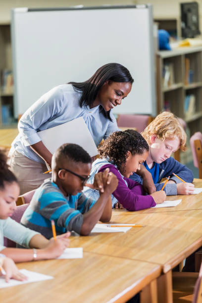 istock African-American teacher with elementary students 1169255937