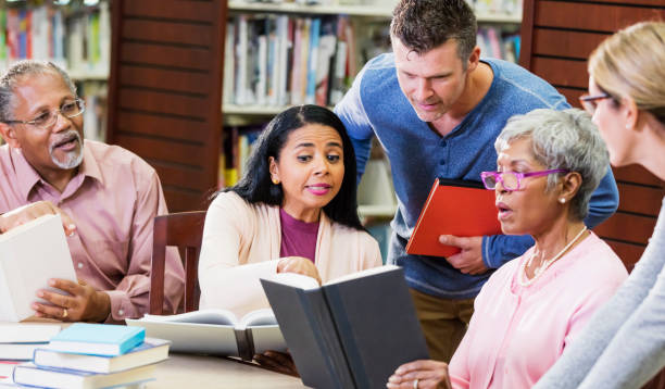 istock Diverse group of adult students conversing in library 1169256700