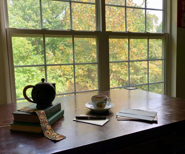 istock Tea and letter writing by a paned window 1169256713