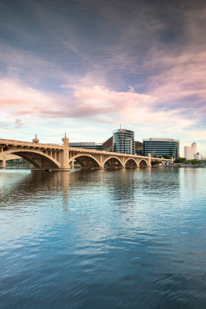 Skyline view of Tempe Arizona and the Mill Avenue bridge Cityscape shore view of downtown Tempe Arizona USA over the Salt River and Mill Avenue Bridge salt river photos stock pictures, royalty-free photos & images