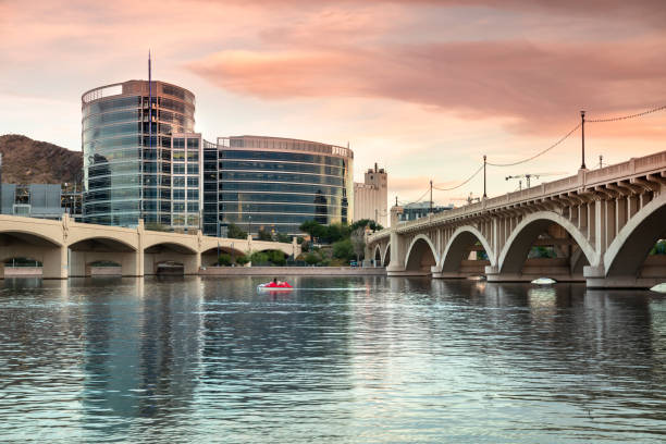 Skyline view of Tempe Arizona and the Mill Avenue bridge Cityscape shore view of downtown Tempe Arizona USA over the Salt River and Mill Avenue Bridge southwest usa architecture building exterior scottsdale stock pictures, royalty-free photos & images