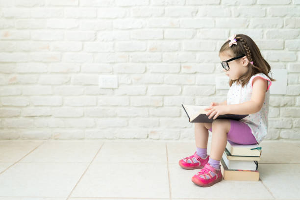 istock Kid Reading Textbooks At Living Room 1169260564