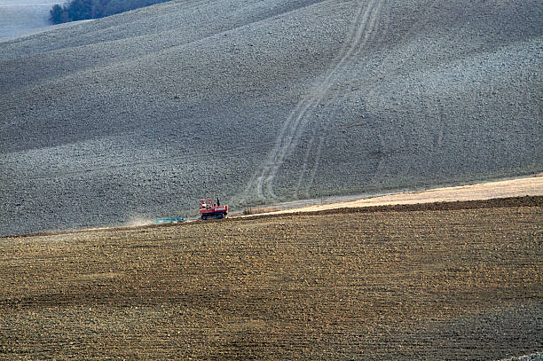 istock Undulating hills and farm tractor 116926430