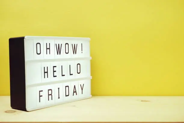 Hello Friday text in lightbox with space copy on yellow background