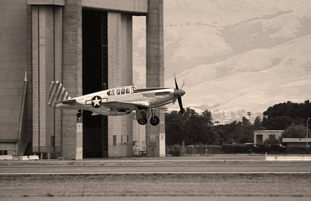 World War II era fighter takes off in front of Hangars 2 and 3 at Moffett Field, California, USA. P-51.