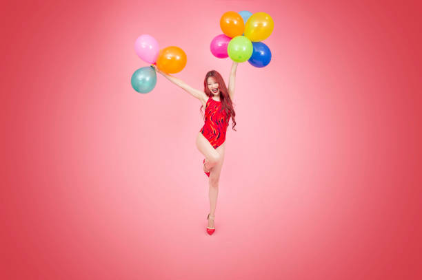 istock Happy balloons woman 1169265326