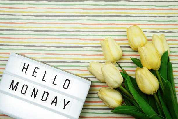 istock Top view Happy Monday Text in Light box flat lay with tulip flower bouquet 1169267836