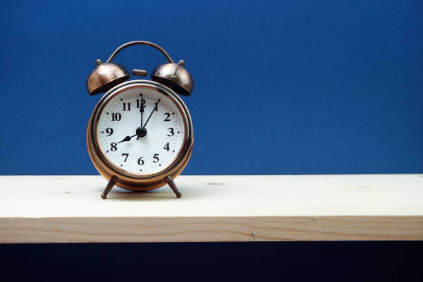istock Vintage alarm clock with space copy on blue background 1169268173