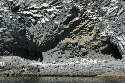 Joints in basalt release stress in rock. White guano caps rock. Isla Partida Norte, Baja California, Mexico. Islands and Protected Areas of the Gulf of Mexico UNESCO World Heritage Site (Biosphere Reserve).