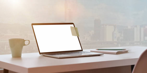 istock Modern workplace with laptop and city view background 1169269869