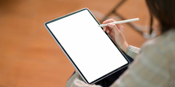istock Young businesswoman writing on blank screen tablet 1169269873