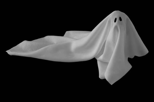 istock White ghost sheet costume rise up from the floor with black background. 1169271514