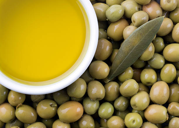 Olive oil dispenser with tag isolated on gray background.