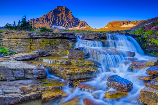 Reynolds creek waterfalls and Mount Reynolds at Logan Pass in Glacier National Park in Montana USA