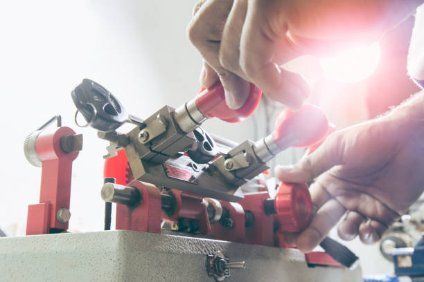 istock Locksmith in workshop makes new key. Professional making key in locksmith. 1169281308