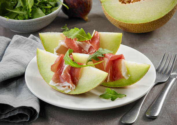istock Melon slices with prosciutto ham 1169284394