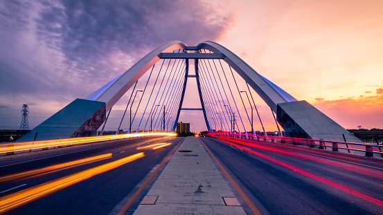 car trails at lowry bridge in minneapolis at sunset