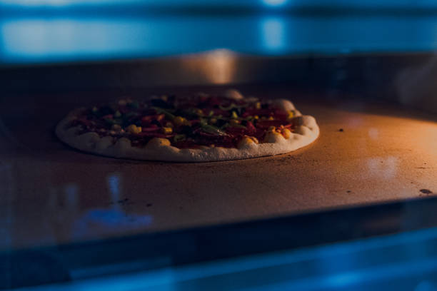 Baked pizza on a shovel , just baked from the wood oven