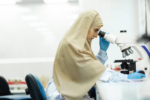 istock Attentive Muslim woman working with professional microscope 1169292795