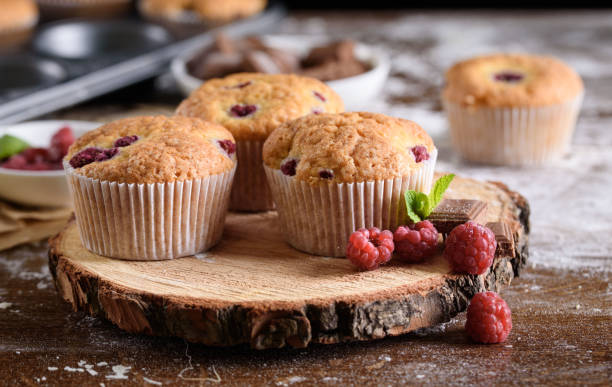 istock Delicious flavored cupcake with raspberries, white cream, and chocolate icing. 1169294104