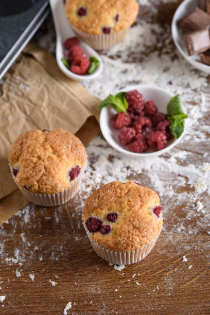 istock Delicious flavored cupcake with raspberries, white cream, and chocolate icing. 1169294108