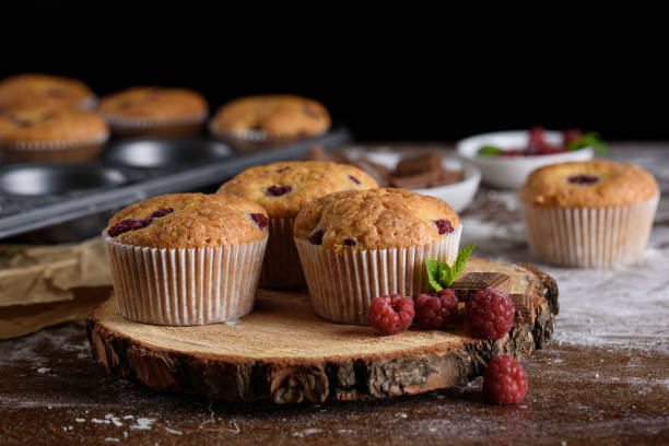 istock Delicious flavored cupcake with raspberries, white cream, and chocolate icing. 1169294151