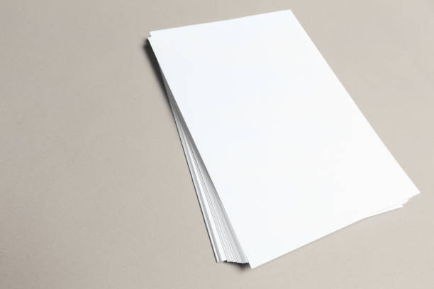 istock Blank paper on wood table 1169294398