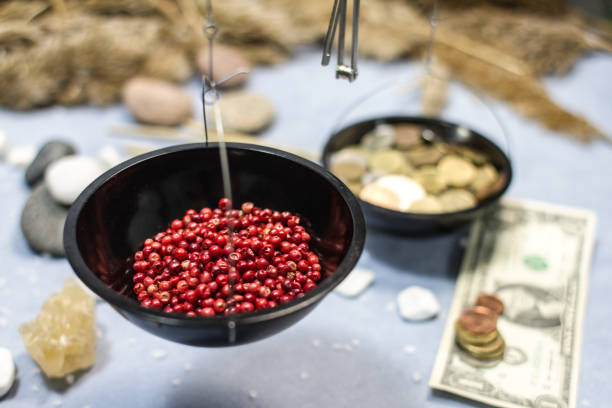 Collage with weights, red, round pepper and money. Various spices on a blue background. There is food on one side of the scale, and various coins on the other side. Remuneration of the farmer, peasant, hard worker.