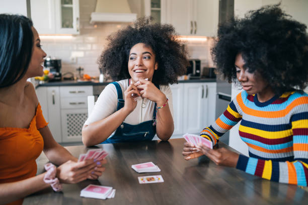 Three girls at home playing cards Three girls at home playing cards three gorges photos stock pictures, royalty-free photos & images